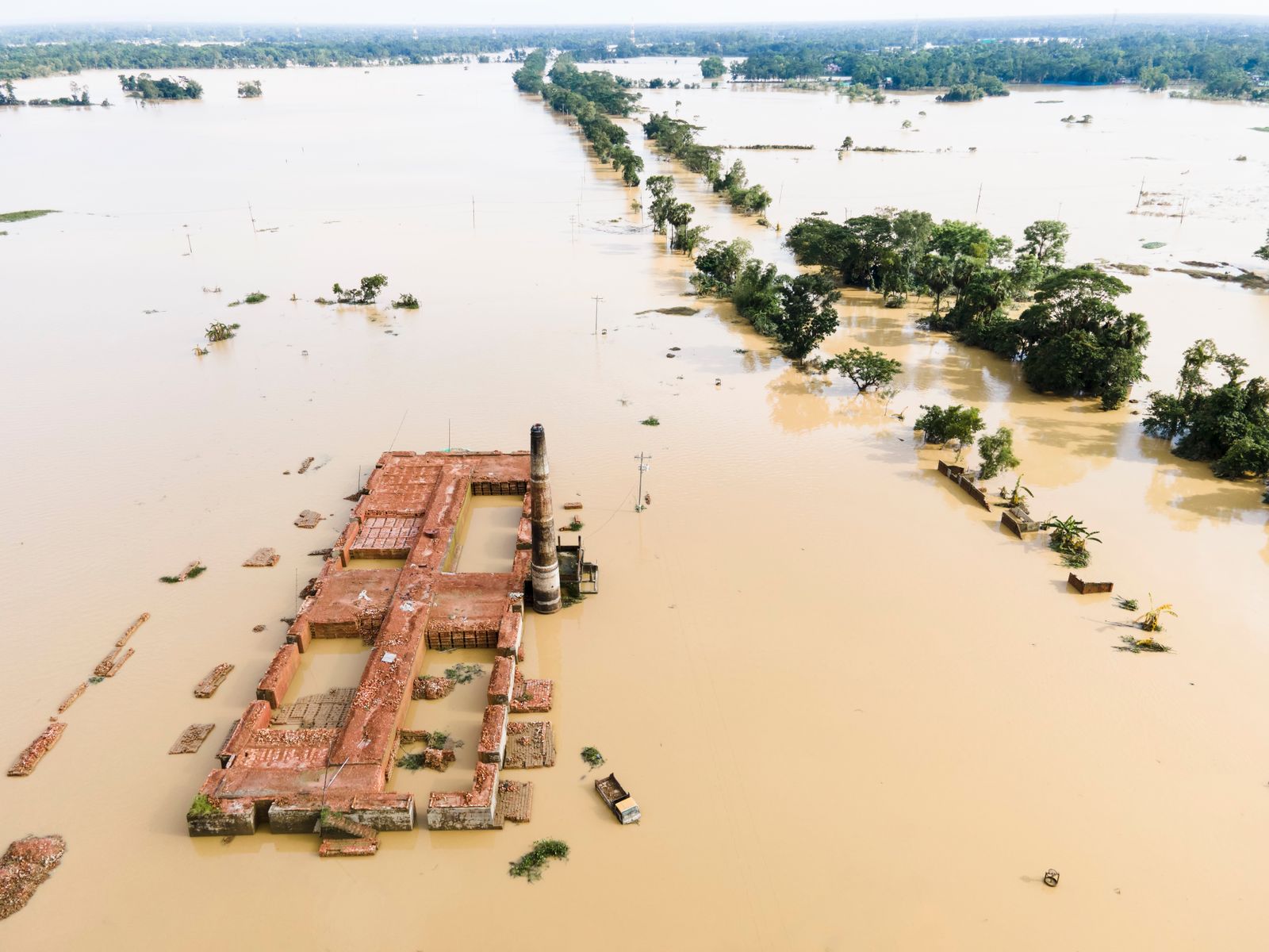 Aerial view of floodwater covering fields and a brick factory